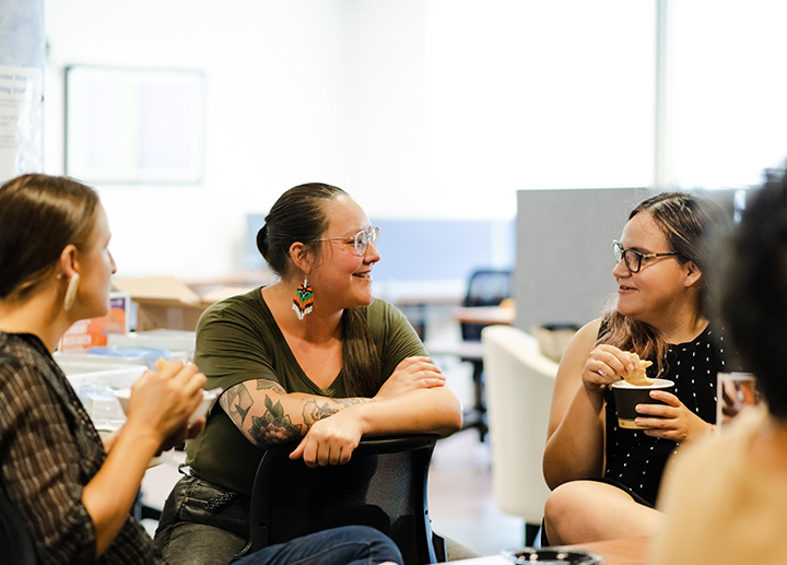 Group of people sitting around each other in a circle and talking